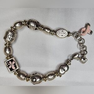 Brighton breast cancer awareness bracelet featuring a pink enamel flower charm. 